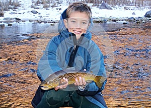Child fishing - holding a large trout