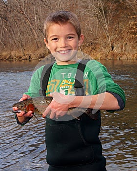 Child fishing - holding a Rainbow Trout