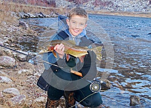 Child fishing - holding a trophy trout