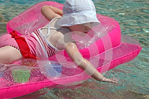 Child floats on an inflatable mattress