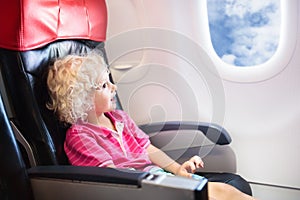 Child flying in airplane. Flight with kids.