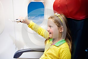 Child flying in airplane. Flight with kids.