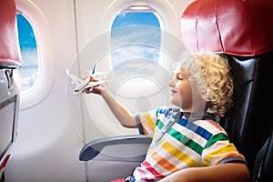 Child flying in airplane. Flight with kids.