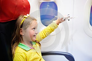 Child flying in airplane. Flight with kids