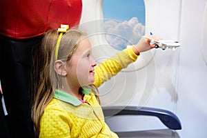 Child flying in airplane. Flight with kids