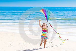 Child flying kite on tropical beach