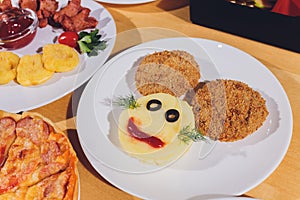Child food. Funny food. Plate with cutlets and mashed potatoes in the form of a monkey faces. Children`s menu.