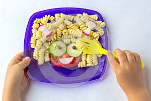 Child food. Funny food. Plate with pasta