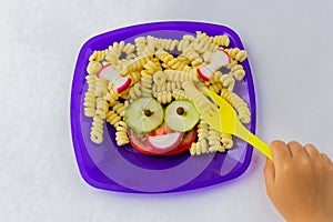 Child food. Funny food. Plate with pasta