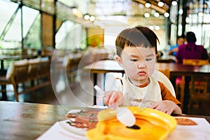 Child with frown face when eating