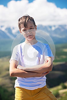 A child funny boy on the Altai mountain background. photo