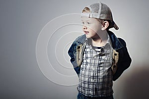 Child. Funny Little Boy in Jeans. Trucker cap. joy. Fashionable Kid. plaid shirt. Denim Wear