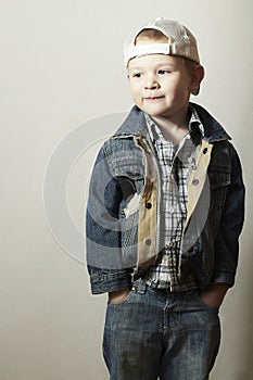 Child. Funny Little Boy in Jeans. Trucker cap. joy. Fashionable Kid. plaid shirt. Denim Wear