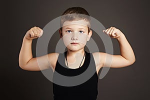 Child.Funny Little Boy showing his muscles