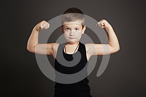Child.Funny Little Boy showing his muscles