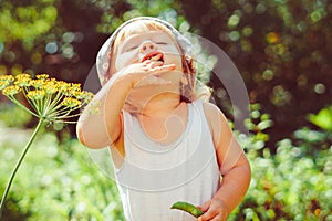 child in the garden with berries