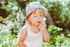 child in the garden with berries