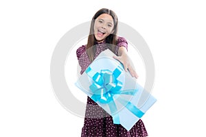 Child with gift present box on isolated studio background. Gifting for kids birthday. Portrait of emotional amazed