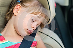 Child girl asleep in a car