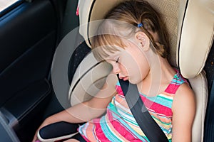 Child girl asleep in a car