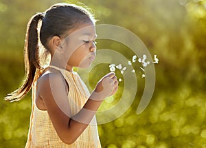 Child, girl or blowing dandelion flower in summer garden, nature park or sustainability environment in wish, hope or
