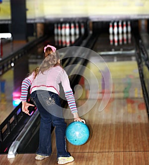 Child girl in with bowling ball.