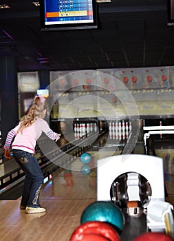 Child girl in with bowling ball.