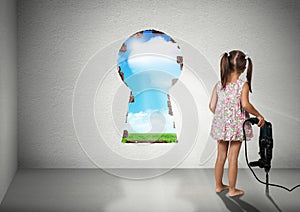 Child girl break wall shape of keyhole, cognition creative conce photo