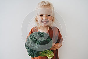 Child girl with broccoli healthy food vegan eating lifestyle organic vegetables plant based diet