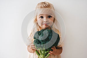 Child girl with broccoli organic vegetable food healthy lifestyle vegan menu plant based diet