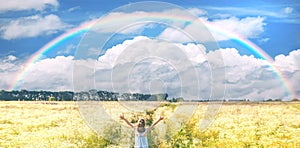 Child girl in a camomile field rainbow. Selective focus.