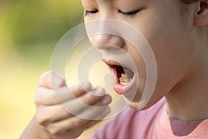 Child girl checking breath with her hand,woman doing a bad breath test after have breakfast,foul mouth from inside the tongue,