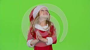 Child girl in the Christmas costumes inflate the stellar pollen. Green screen. Slow motion