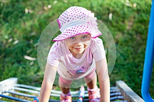 Child girl climbing by the rope ladder