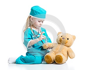 Child girl with clothes of doctor playing toy