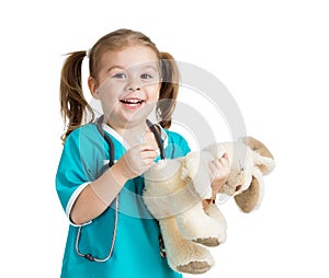 Child girl with clothes of doctor with plush toy over white