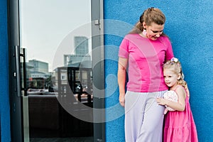 Child girl with cochlear implant with her mother spend time outdoor. Hear impairment and deaf community concept. Deaf