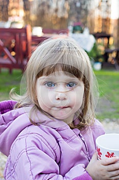 Child girl with a cup of tea