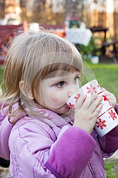 Child girl with a cup of tea