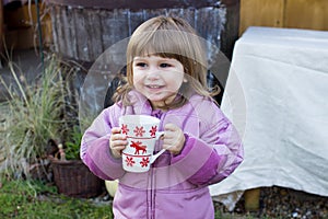 Child girl with a cup of tea