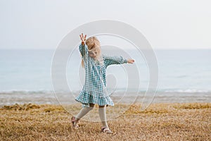 Child girl dancing on the beach kid 4 years old family travel outdoor