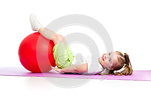 Child girl doing fitness exercise with fitness