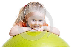 Child girl doing fitness exercise with fitness