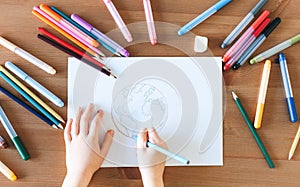 Child girl drawing with colorful pencils