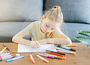 Child girl drawing with colorful pencils