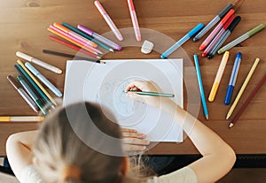 Child girl drawing with colorful pencils