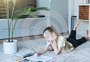 Child girl drawing with colorful pencils