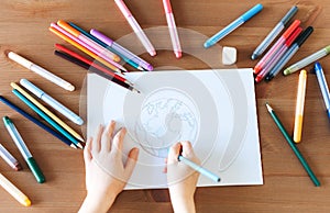 Child girl drawing with colorful pencils