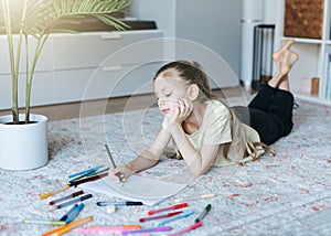 Child girl drawing with colorful pencils