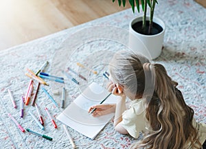 Child girl drawing with colorful pencils